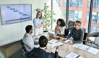 Diverse corporate team working together in modern meeting room office